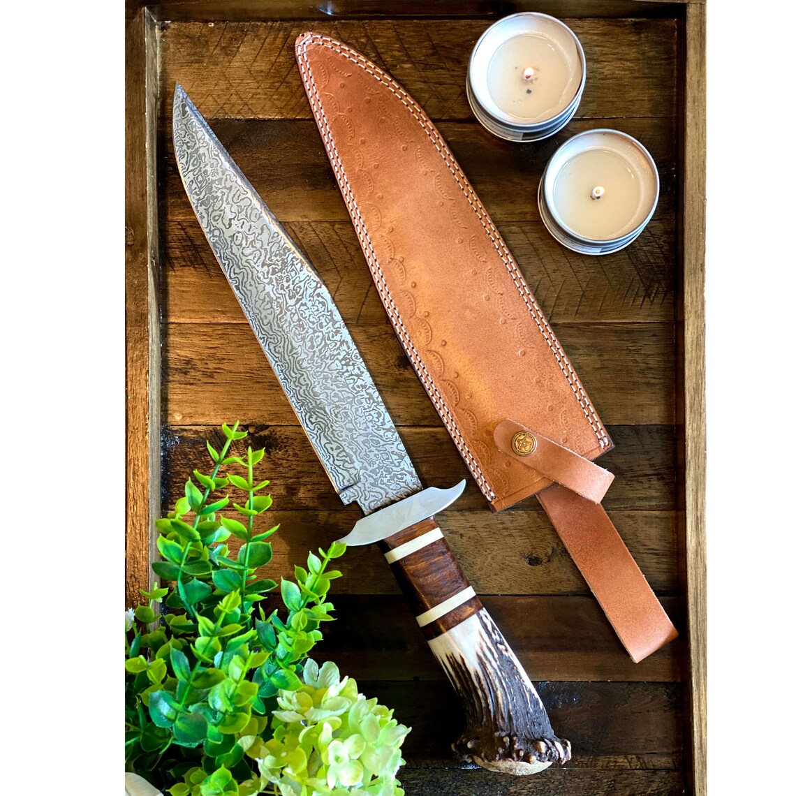 Custom handmade Damascus steel Bowie knife with stag crown handle, rosewood guard, and leather sheath, 15-inch length.