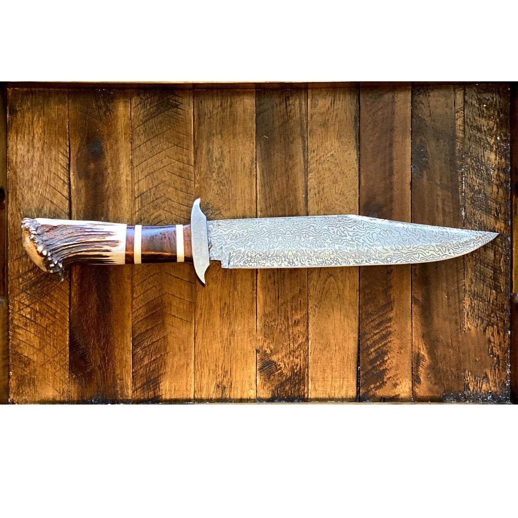 Custom handmade Damascus steel Bowie knife with stag crown handle, rosewood guard, and leather sheath, 15-inch overall length.