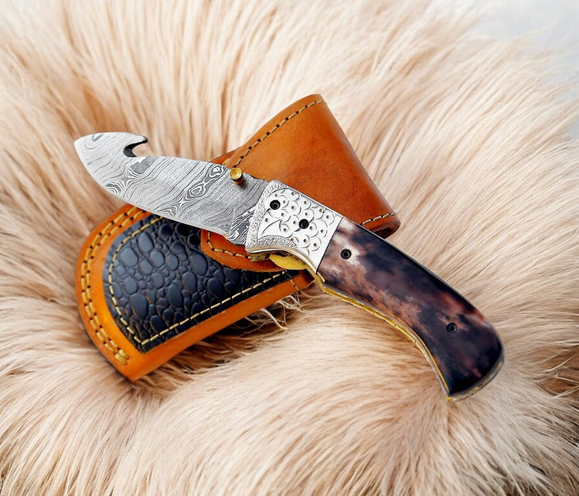 Custom handmade Damascus pocket knife with a vibrant colored bone handle and polished blade, crafted by Damascus Knife Store.