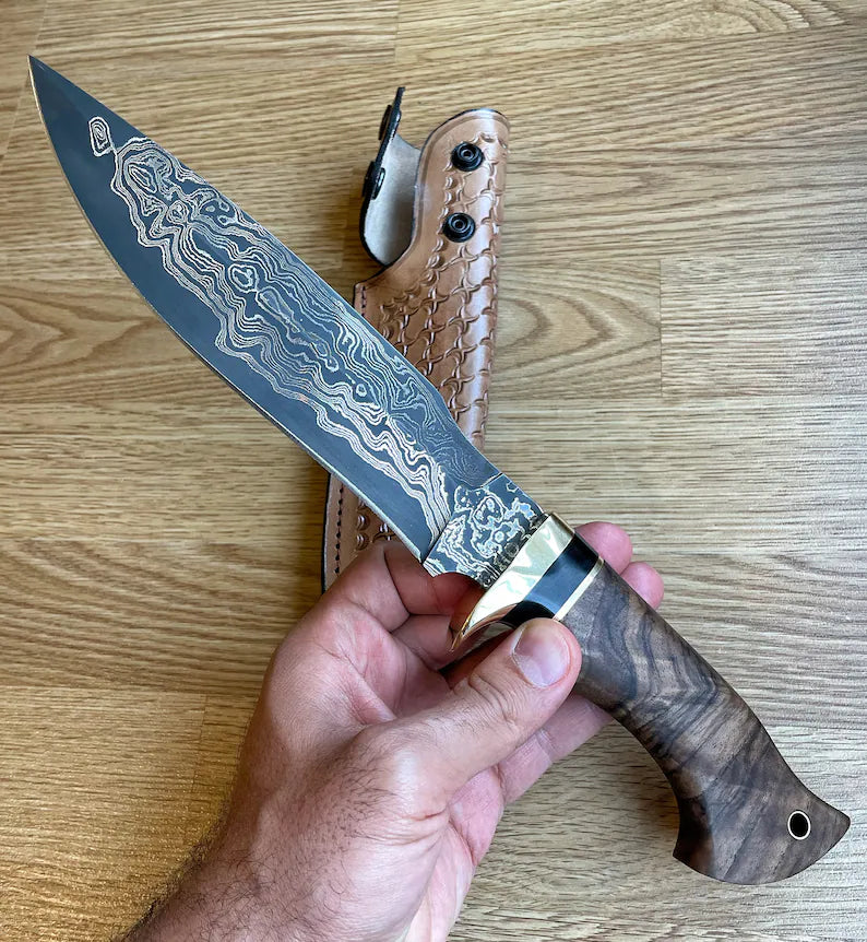 Custom handmade Damascus steel Bowie knife with brass guard and rosewood handle, includes leather sheath, crafted by Knives Gear Garage.