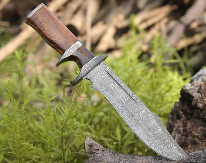 Custom handmade Damascus steel Bowie knife with rosewood handle, 13-inch blade, Damascus steel guard, and leather sheath.