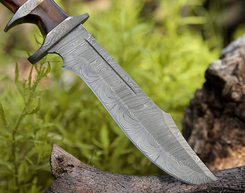 Custom handmade Damascus steel Bowie knife with rosewood handle, 13-inch blade, Damascus steel guard, and leather sheath.