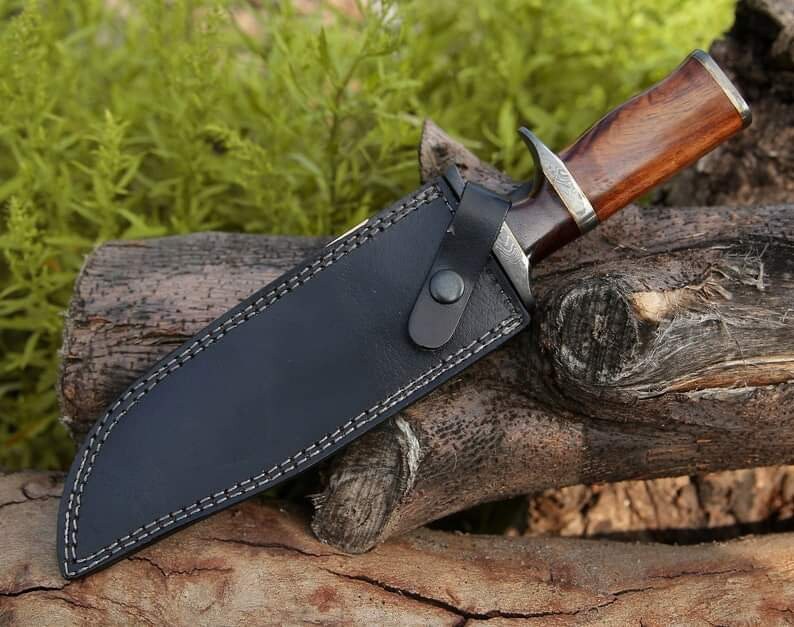 Custom handmade Damascus steel Bowie knife with rosewood handle, leather sheath, and Damascus steel guard from Knives Gear Garage.