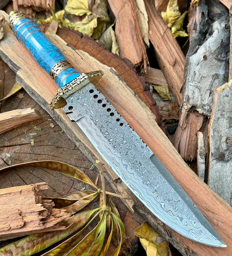 Custom handmade Damascus steel Bowie knife with leather handle, brass guard, resin inlay, and leather sheath.