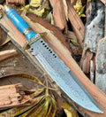 Custom handmade Damascus steel Bowie knife with leather handle, brass guard, resin inlay, and leather sheath.
