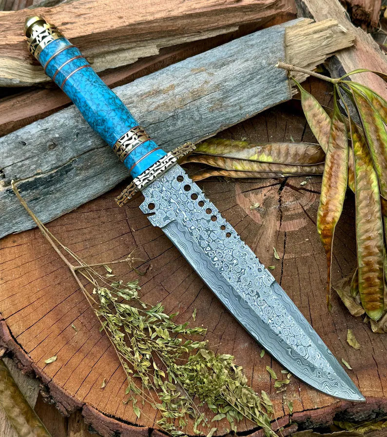 Custom handmade Damascus steel Bowie knife with leather handle, brass guard, resin inlay, and leather sheath from Knives Gear Garage