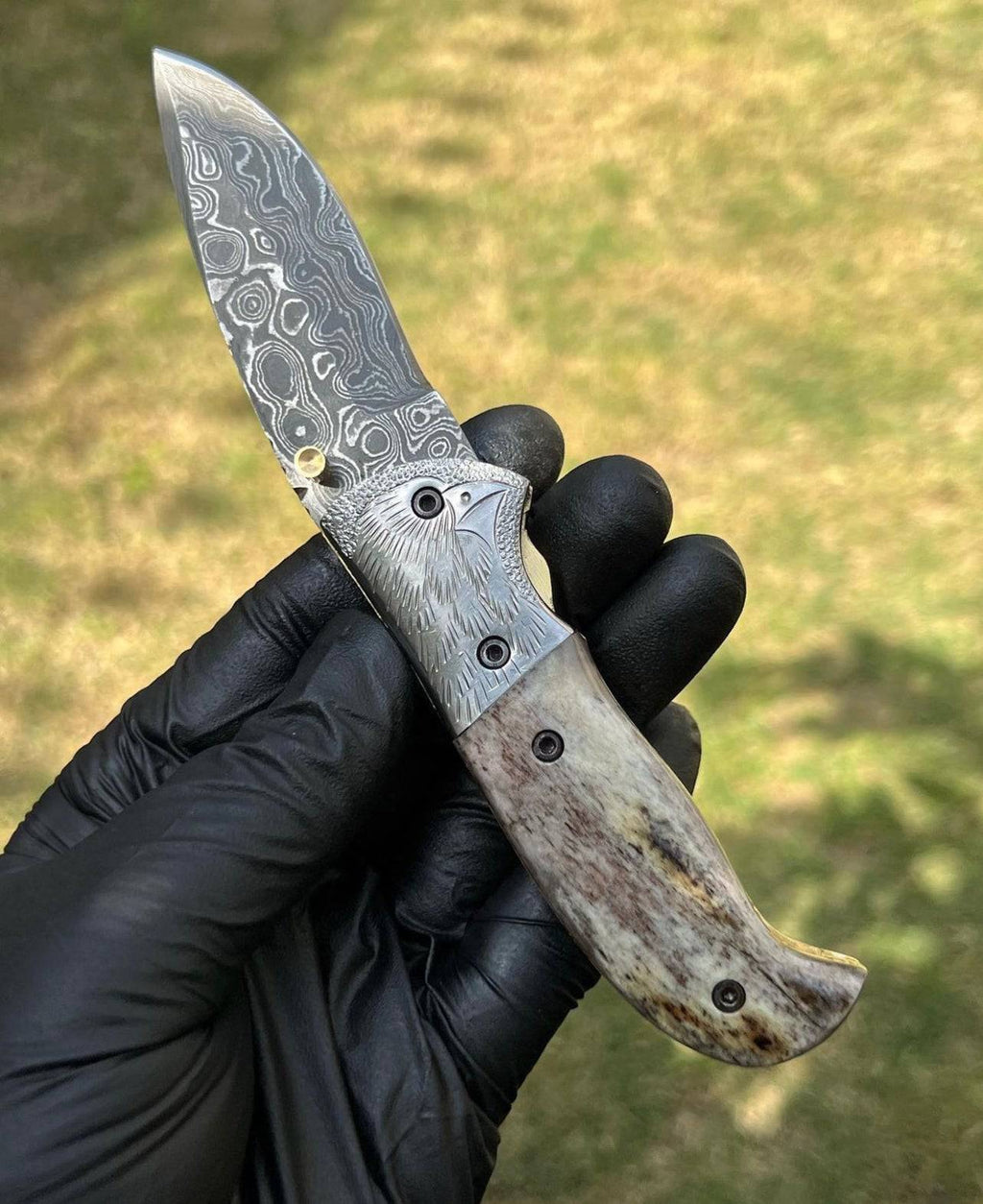 Damascus pocket folding knife by cskforged with intricate layered steel blade and ergonomic handle, suitable for everyday carry.