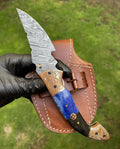 Damascus Blade EDC folding pocket knife by cskforged with a patterned Damascus steel blade and a sleek handle.