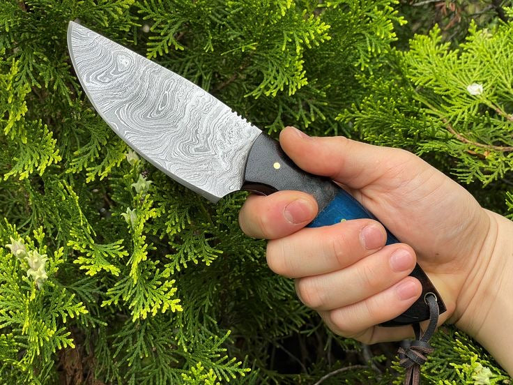 Handmade Damascus Steel knife with full tang from Knives Gear Garage, showcasing the intricate patterned blade and sturdy handle.
