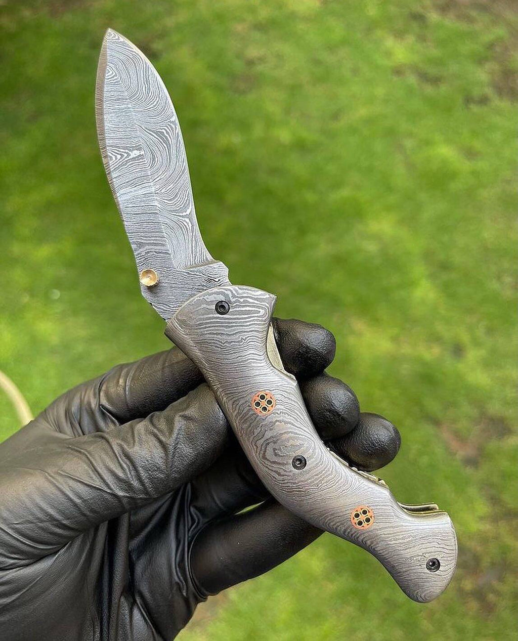 Damascus folding pocket knife with a full blade, featuring intricate patterns, from the CSK Forged EDC collection.