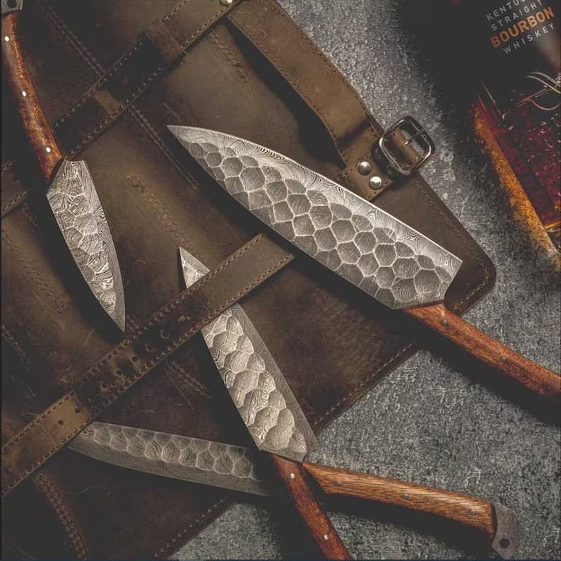 Custom handmade Damascus kitchen knives set by Knives Gear Garage with rosewood handles and a leather roll storage kit.