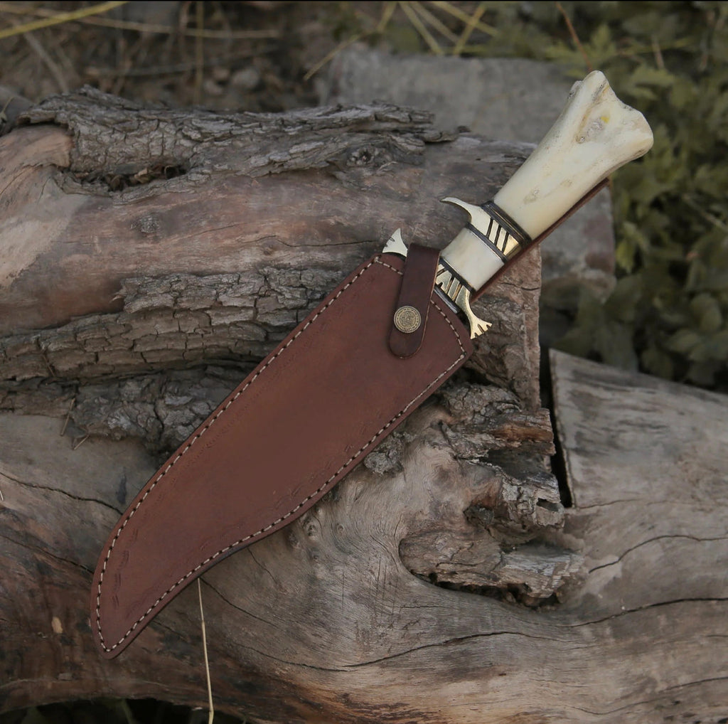 Custom handmade Damascus steel hunting Bowie knife with intricate pattern and leather sheath by Knives Gear Garage.