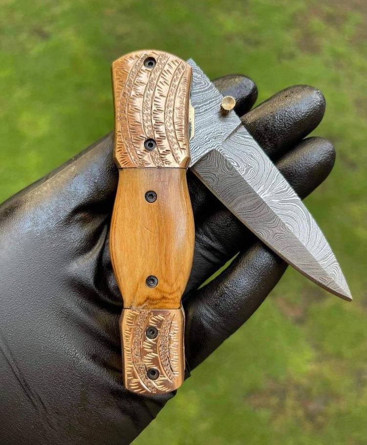 Damascus Blade EDC folding pocket knife by cskforged with a sleek handle and textured blade, ready for everyday carry.