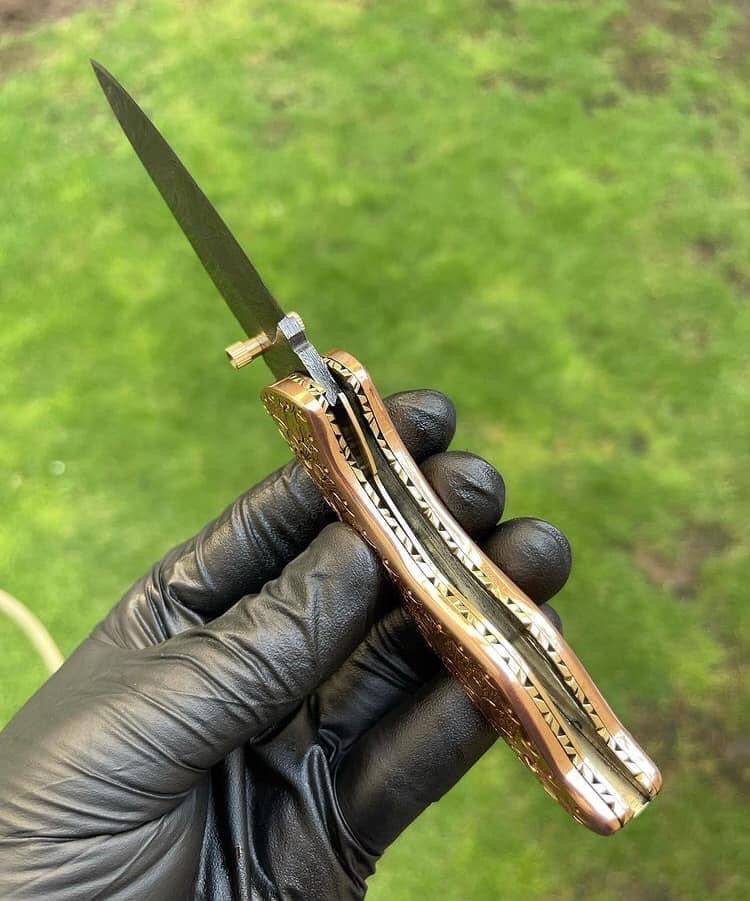 Custom handmade Damascus blade EDC folding pocket knife by cskforged, featuring a detailed Damascus steel handle and sharp cutting edge.