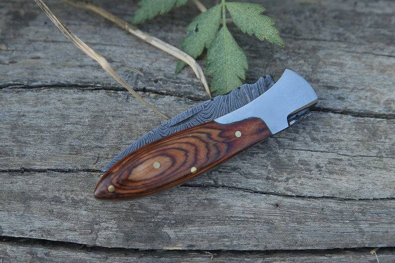 Handmade Damascus pocket knife with brown Pakka wood handle by Knives Gear Garage, featuring a folding blade for everyday carry.