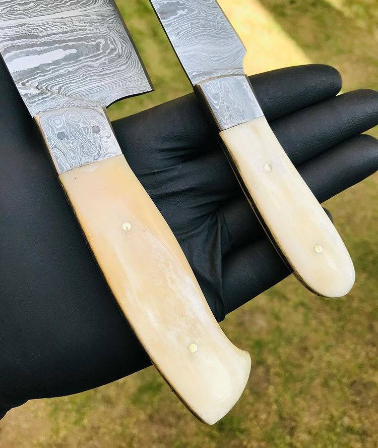 Custom handmade Damascus steel chef knife set by CSK Forged, featuring two high-quality, intricately patterned blades for culinary use.