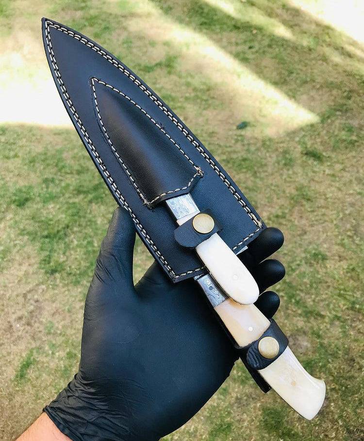 Custom handmade Damascus steel chef knife set by cskforged, featuring two high-quality, intricately patterned knives on a wooden surface.