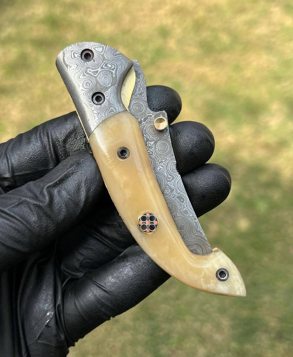 Damascus Blade EDC folding pocket knife by cskforged with a Damascus steel handle and a sleek folding blade.