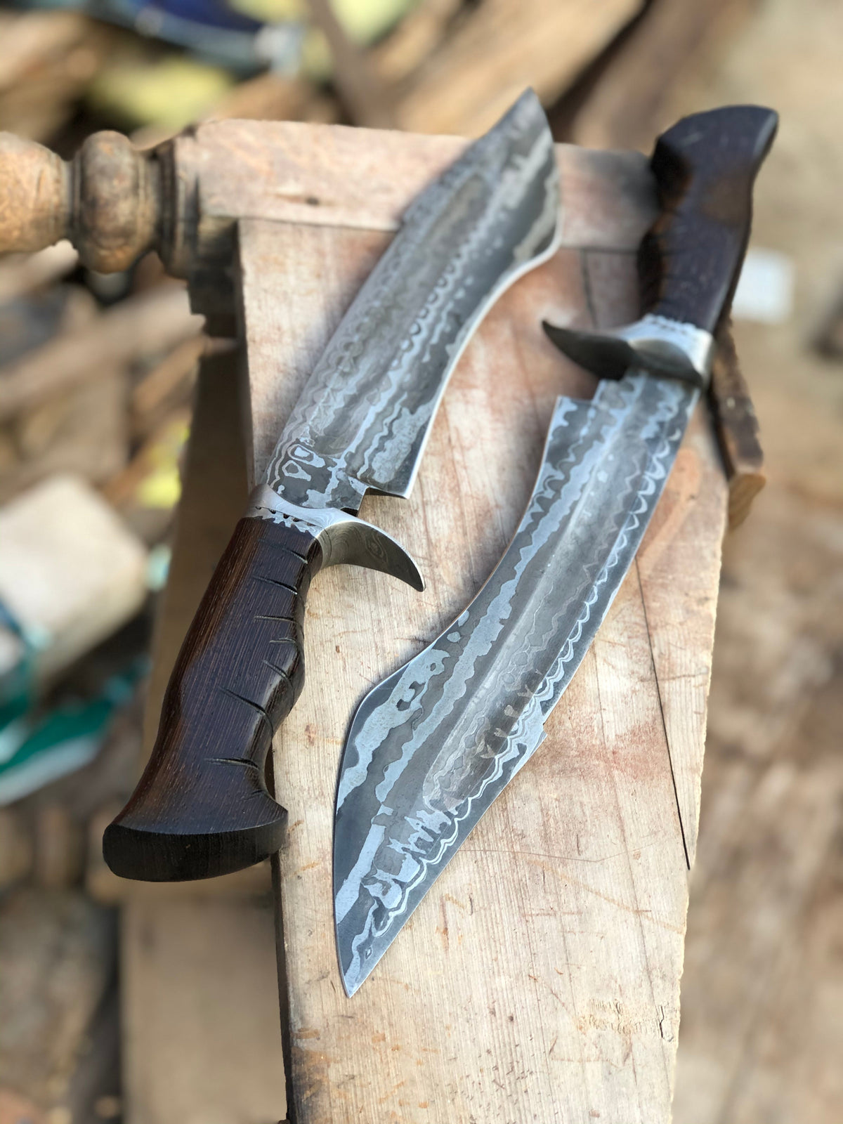 Custom handmade Damascus steel hunting Bowie knife with a leather handle and detailed blade design from Knives Gear Garage.