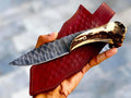 Custom handmade 1095 steel stag horn knife with leather sheath, featuring a detailed blade and handle with rustic leather cover.