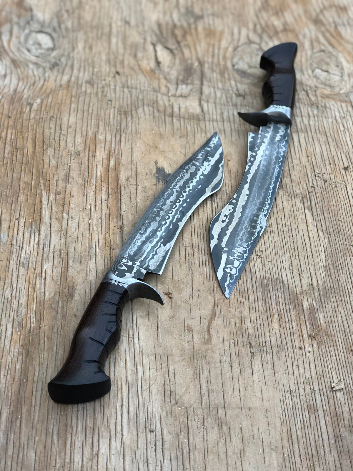 Custom handmade Damascus steel hunting Bowie knife with intricate pattern and leather handle from Knives Gear Garage.