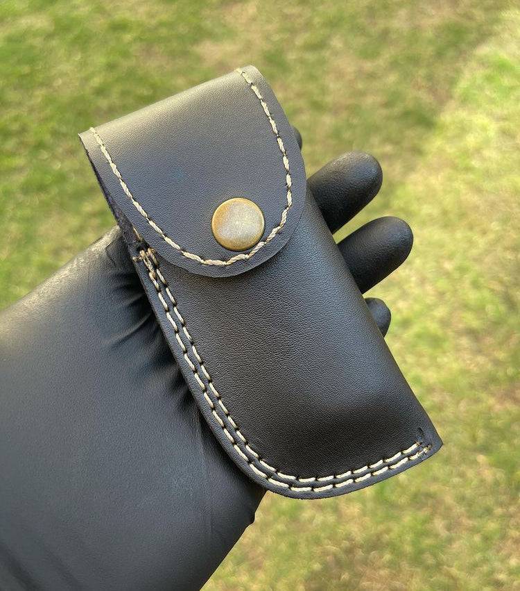 Damascus folding EDC pocket knife by cskforged, featuring a patterned blade and ergonomic handle for everyday carry.