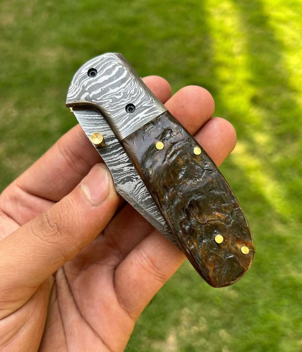 Custom handmade Damascus steel Tanto blade EDC folding pocket knife by cskforged with textured handle and intricate blade pattern.
