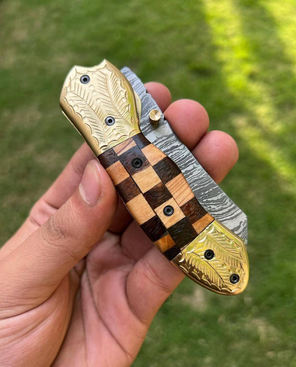 Custom handmade Damascus steel Tanto blade folding pocket knife by CSK Forged, showcasing intricate blade pattern and ergonomic handle.