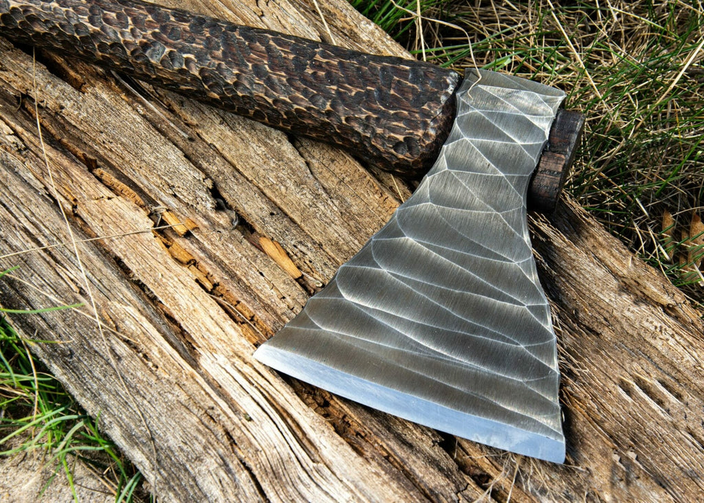 Hand-forged Viking axe with wooden handle and metal blade, crafted by Knives Gear Garage, displayed with detailed close-up.