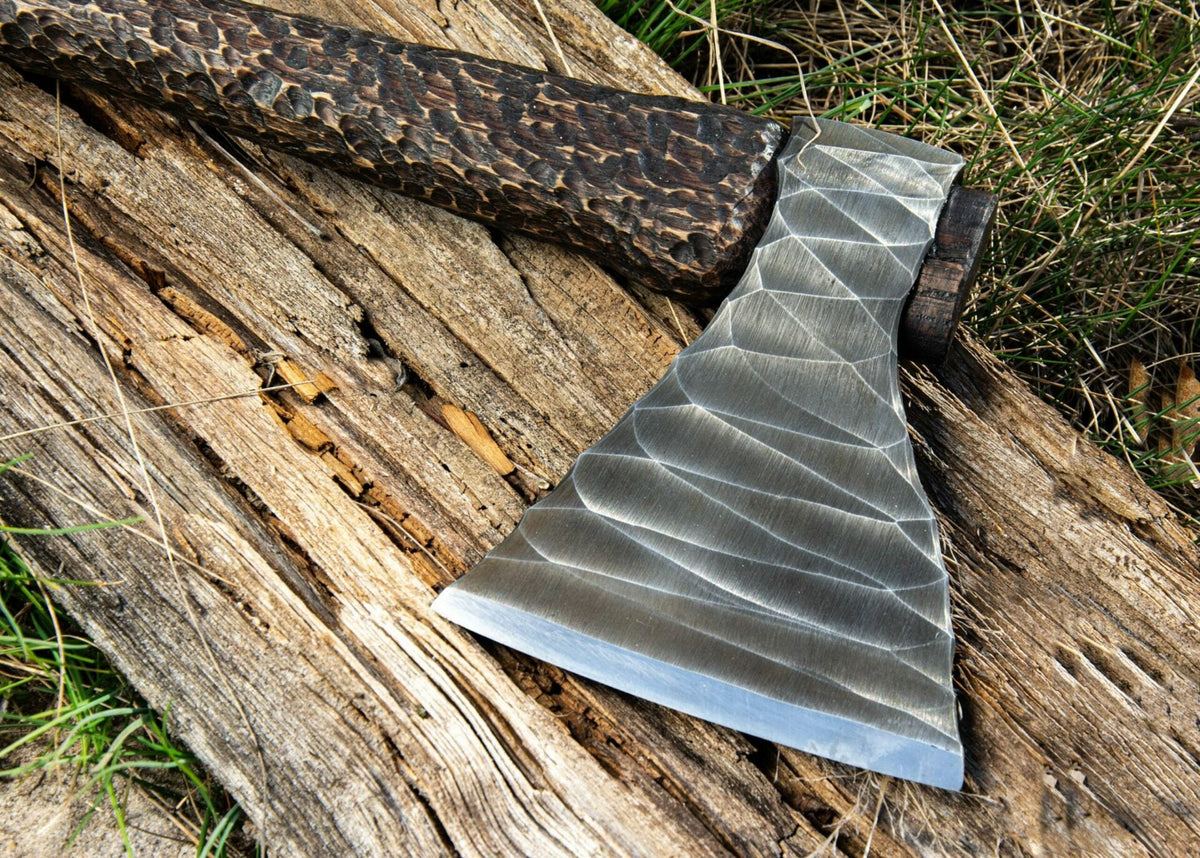 Hand-forged Viking axe with wooden handle and metal blade, crafted by Knives Gear Garage, displayed with detailed close-up.