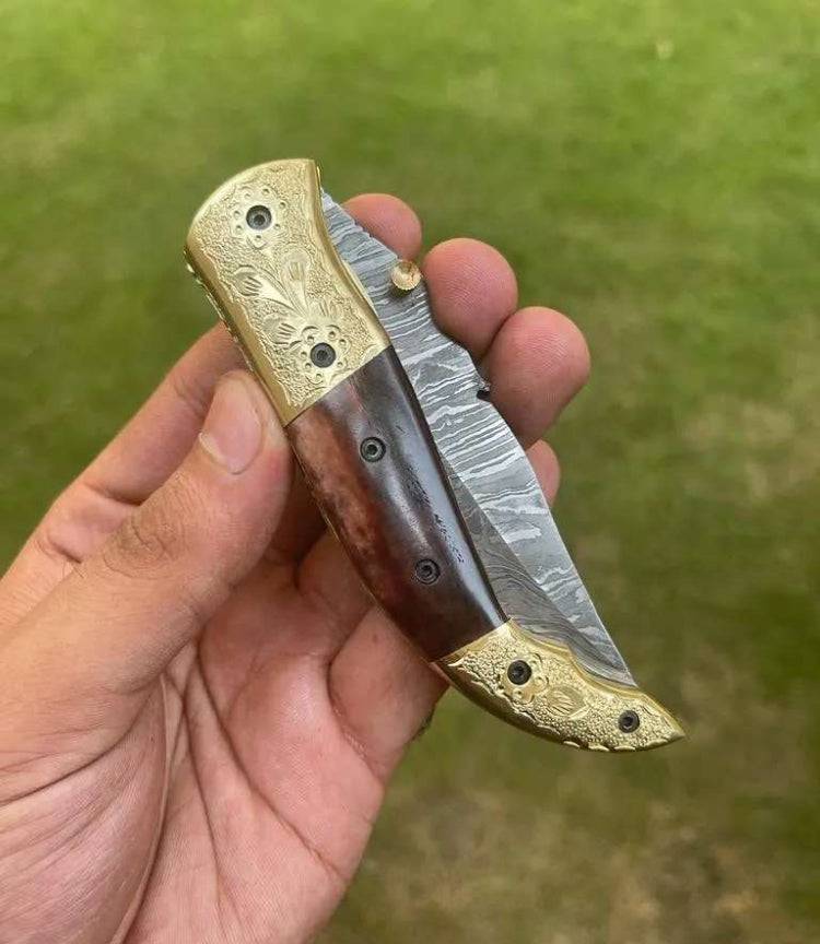 Damascus Blade EDC pocket knife by cskforged with a detailed patterned steel blade and ergonomic handle for everyday carry.