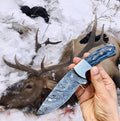 Custom handmade Damascus steel hunting skinning knife with exotic wood handle, steel bolster, and leather sheath.