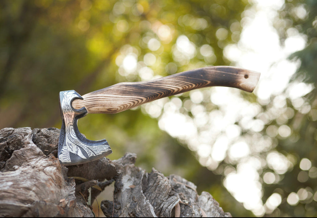 Handmade engraved Viking axe with D2 steel blade and ash wood handle, shown with leather sheath by Knives Gear Garage.