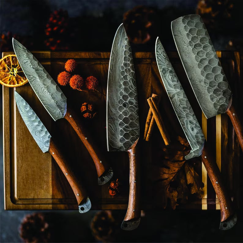 Custom handmade Damascus kitchen knives set with rosewood handles displayed in a leather roll kit, showcasing craftsmanship and premium materials.