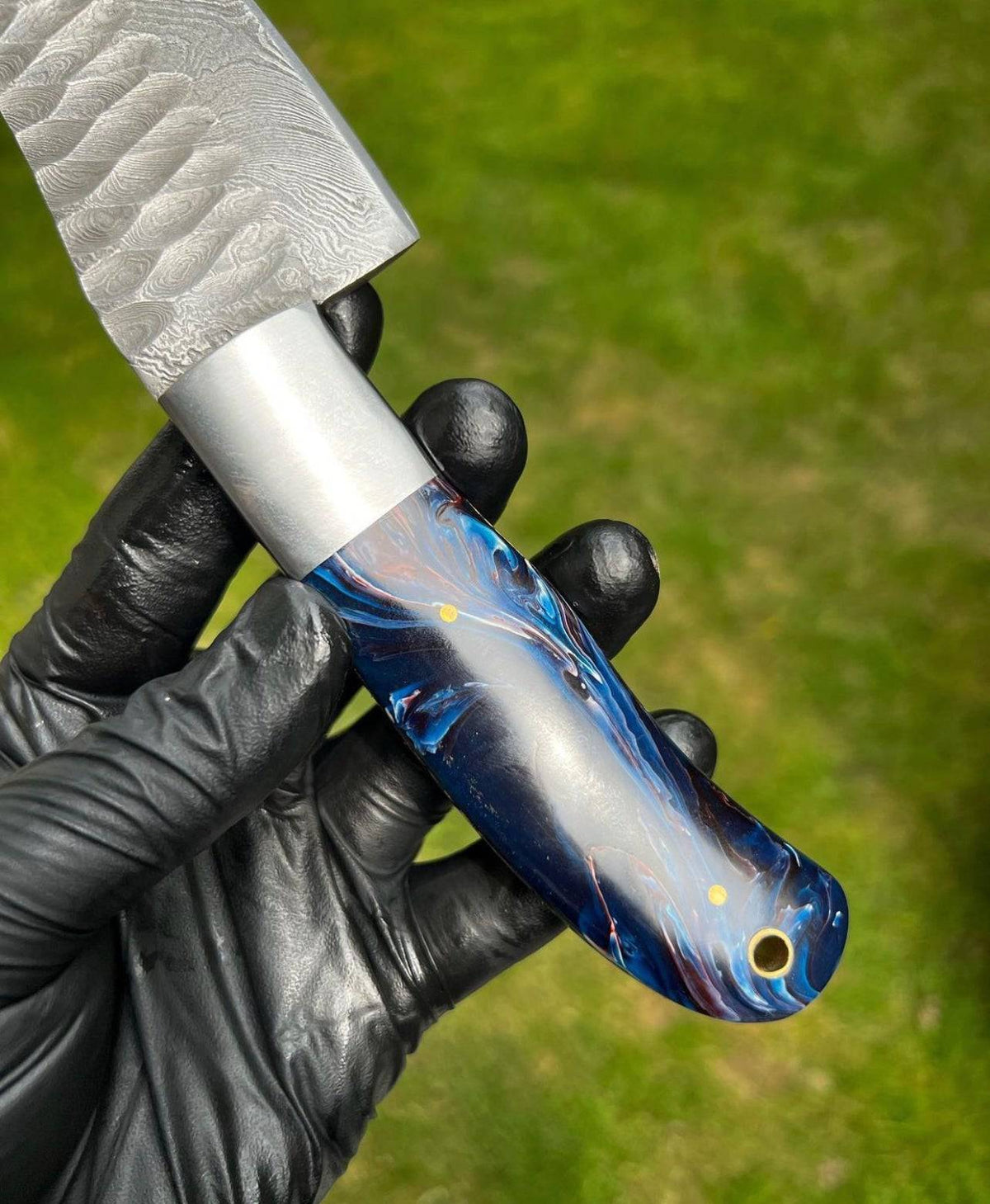 Hand forged Damascus steel chef knife by CSK Forged, showcasing a sharp blade and polished wooden handle for precise cutting.