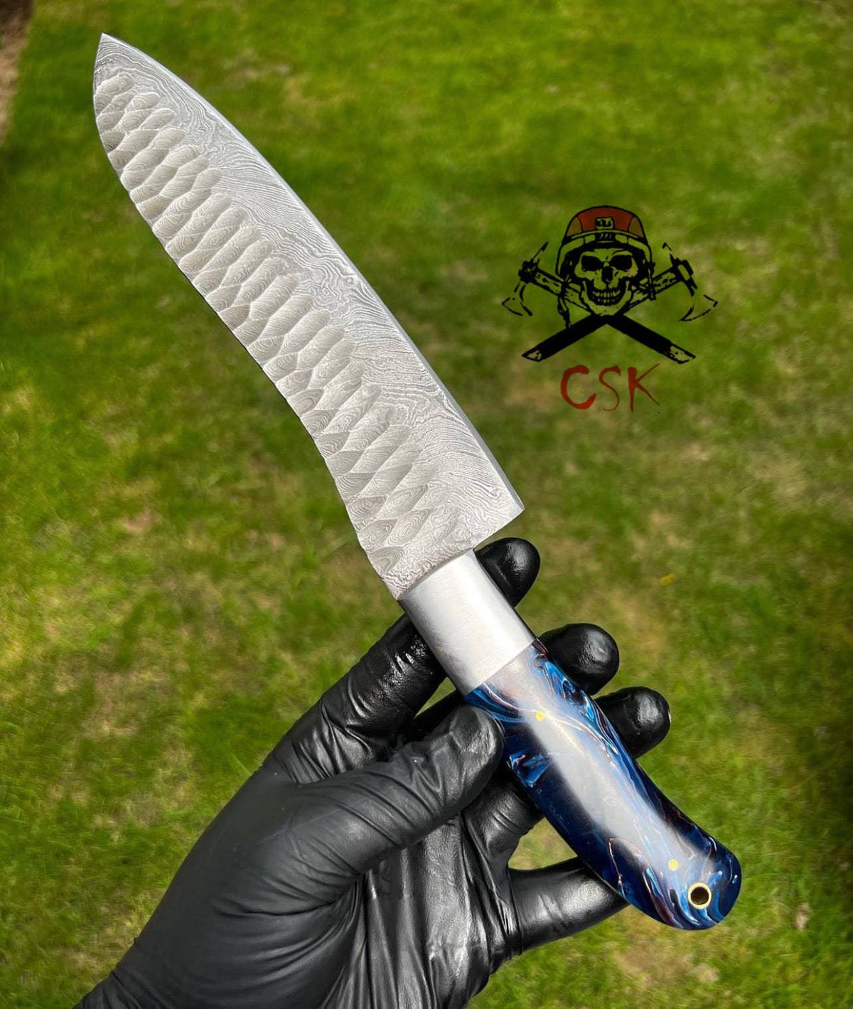 Hand forged Damascus steel chef knife by cskforged with a fixed blade and textured pattern for precision cutting.