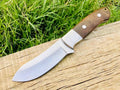 Full tang handmade skinning knife with D2 steel blade from Knives Gear Garage, featuring a textured handle and sharp edge.