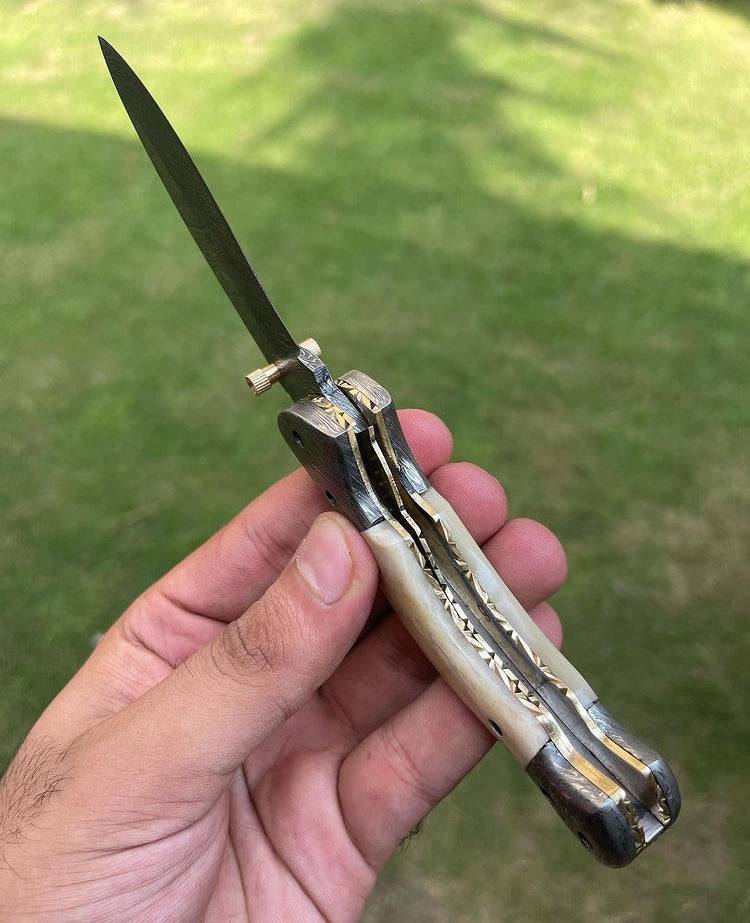 Damascus folding pocket knife by cskforged with a textured blade and ergonomic handle, suitable for everyday carry.