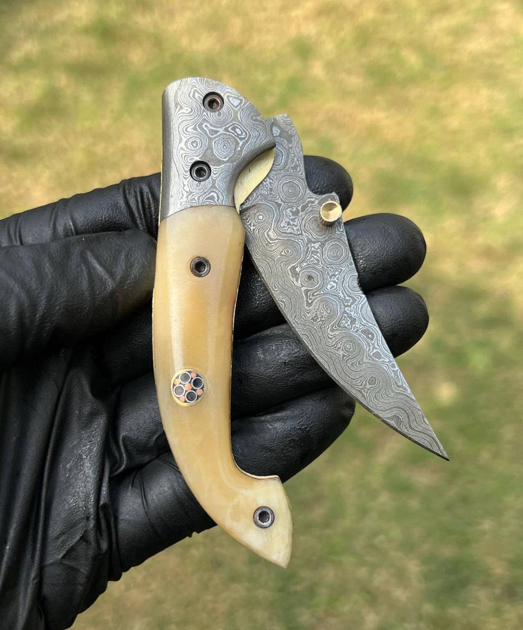 Damascus Blade EDC folding pocket knife by cskforged with intricate Damascus steel pattern and a sturdy folding design.