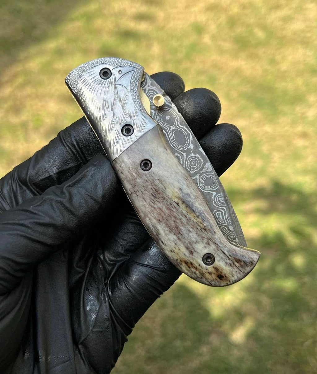 Damascus pocket folding knife by cskforged with a patterned blade and wooden handle, open showcasing its sharp edge and craftsmanship.