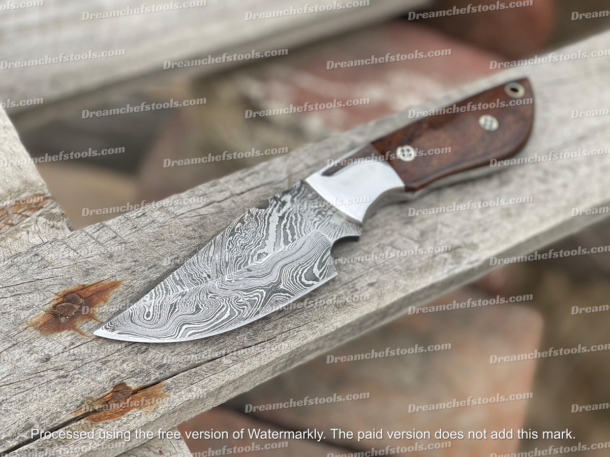 Custom handmade Damascus steel skinning knife with a textured handle and sharp blade, ideal for outdoor hunting and skinning tasks.