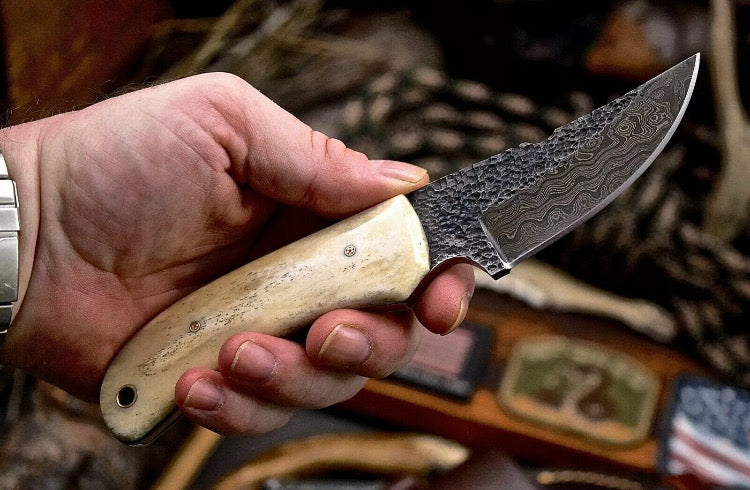 Handmade 7-inch Damascus steel deer skinning knife with camel bone handle and leather sheath from Knives Gear Garage.
