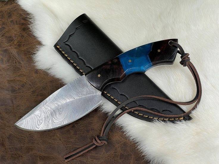 Handmade Damascus steel full tang knife with intricate pattern, featuring a wooden handle and sharp blade from Knives Gear Garage.