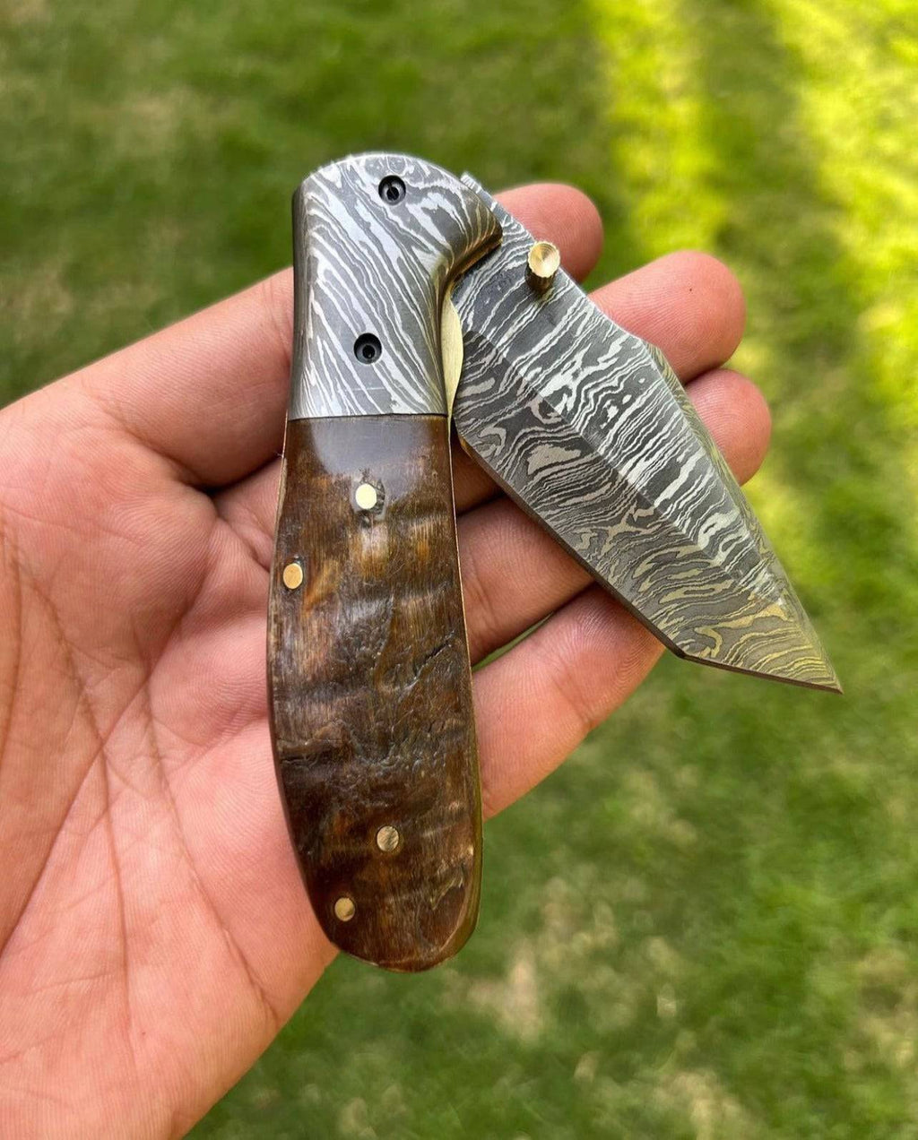Custom handmade Damascus steel Tanto blade folding pocket knife by cskforged, showcasing intricate steel patterns and a sharp, tactical design.