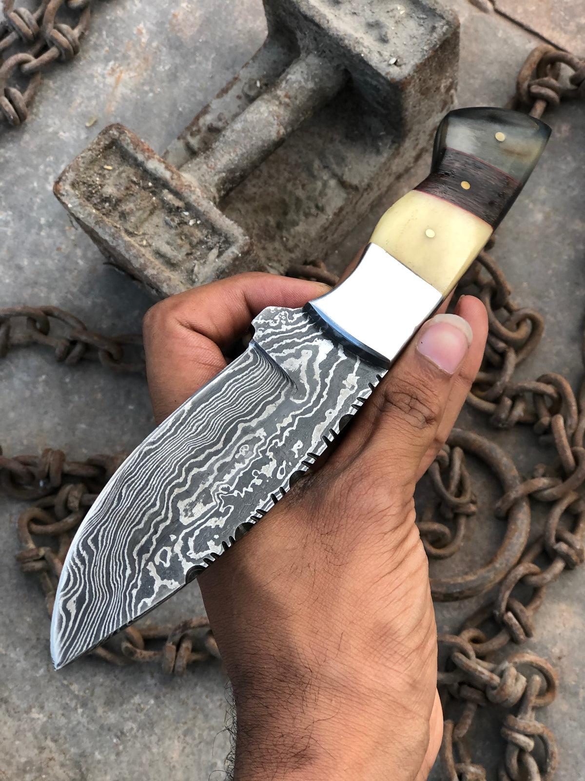 Stainless steel hunting knife from Knives Gear Garage with a black handle and a sharp, durable blade for outdoor use.