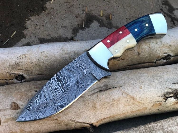 Custom handmade Damascus Texas hunting knife with bone handle, steel bolster, and colorful sheet, crafted by Knives Gear Garage.