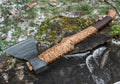 Hand-forged axe from Knives Gear Garage with wooden handle and sharp metal blade, ideal for chopping and outdoor use.