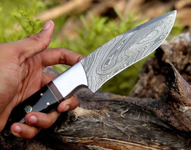 Custom handmade Damascus hunting knife with rosewood and buffalo horn handle, steel bolster, 9-inch blade, with leather sheath.