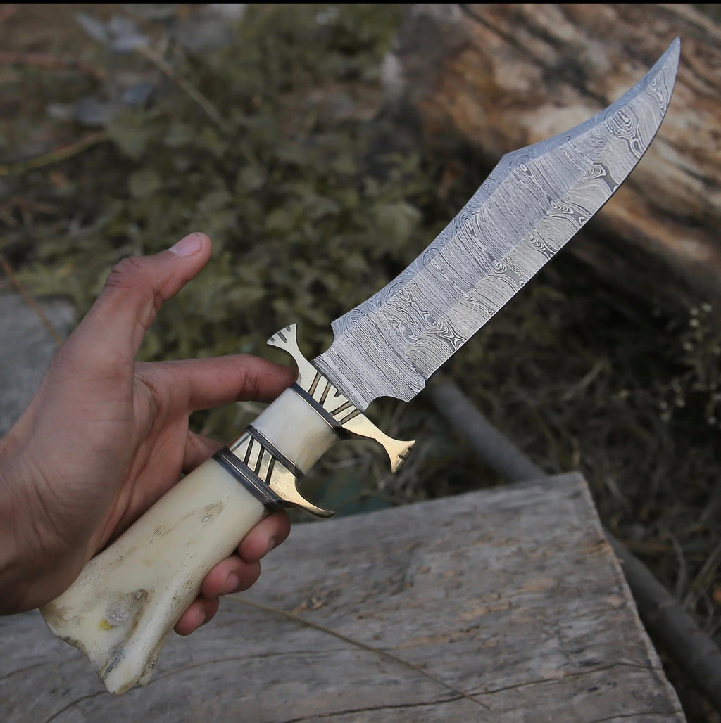 Custom handmade Damascus steel hunting Bowie knife with a leather handle and detailed blade design by Knives Gear Garage.