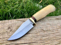 Handmade D2 steel skinning knife with leather handle by Knives Gear Garage, showcasing a sharp blade and ergonomic design.